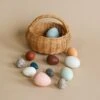 A Dozen Wooden Bird Eggs In A Basket